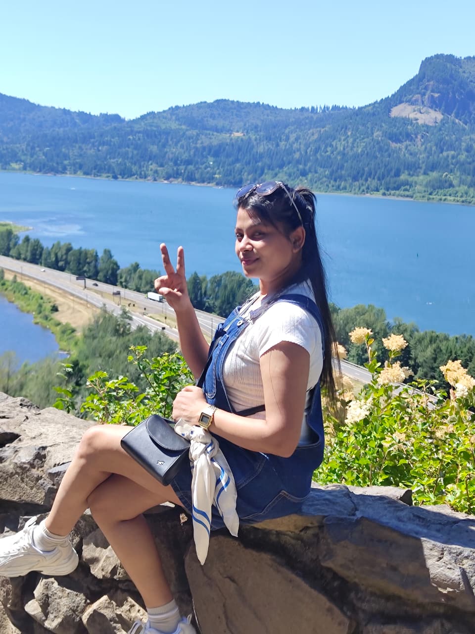 Sanskriti sitting on a rock overlooking the Columbia River Gorge
