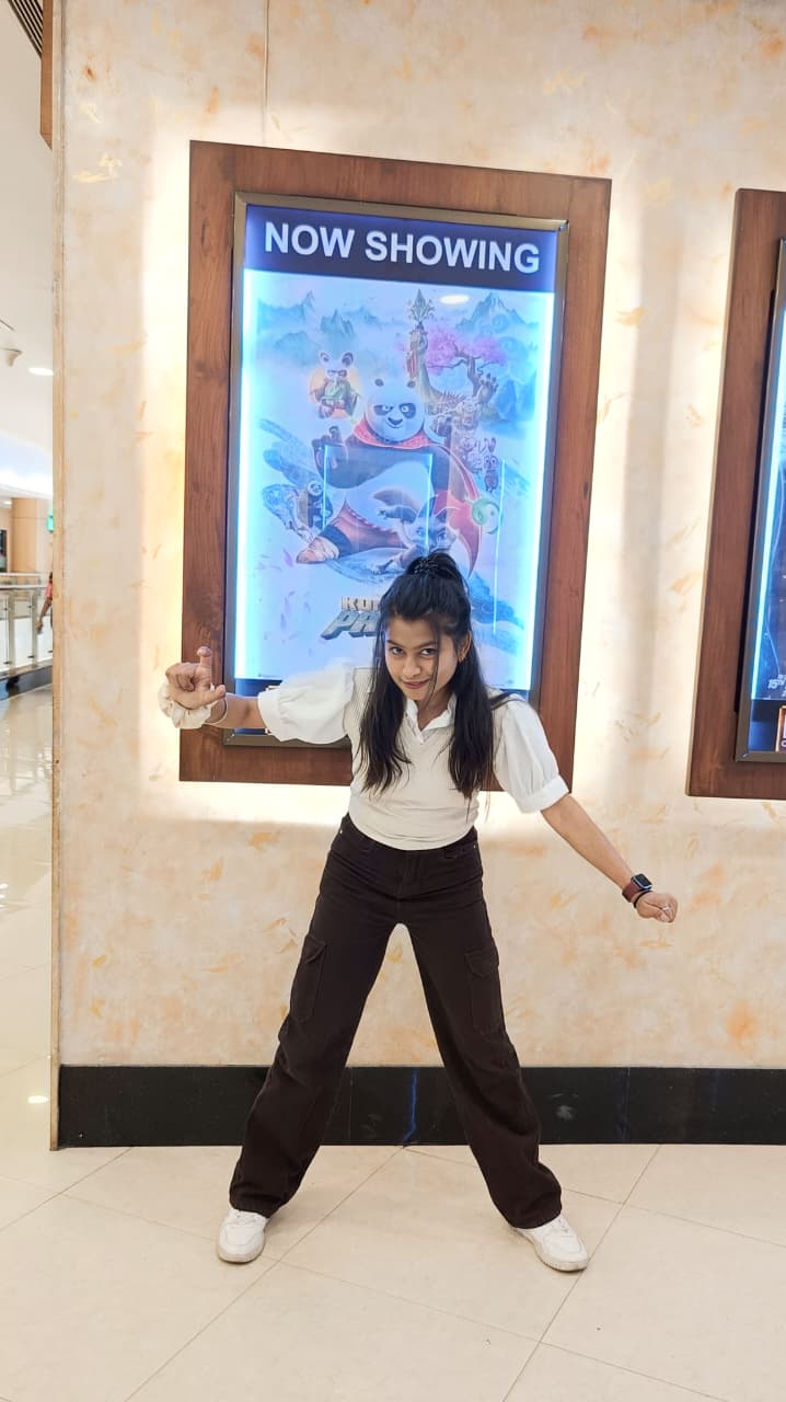 Sanskriti striking a playful kung fu pose in a mall